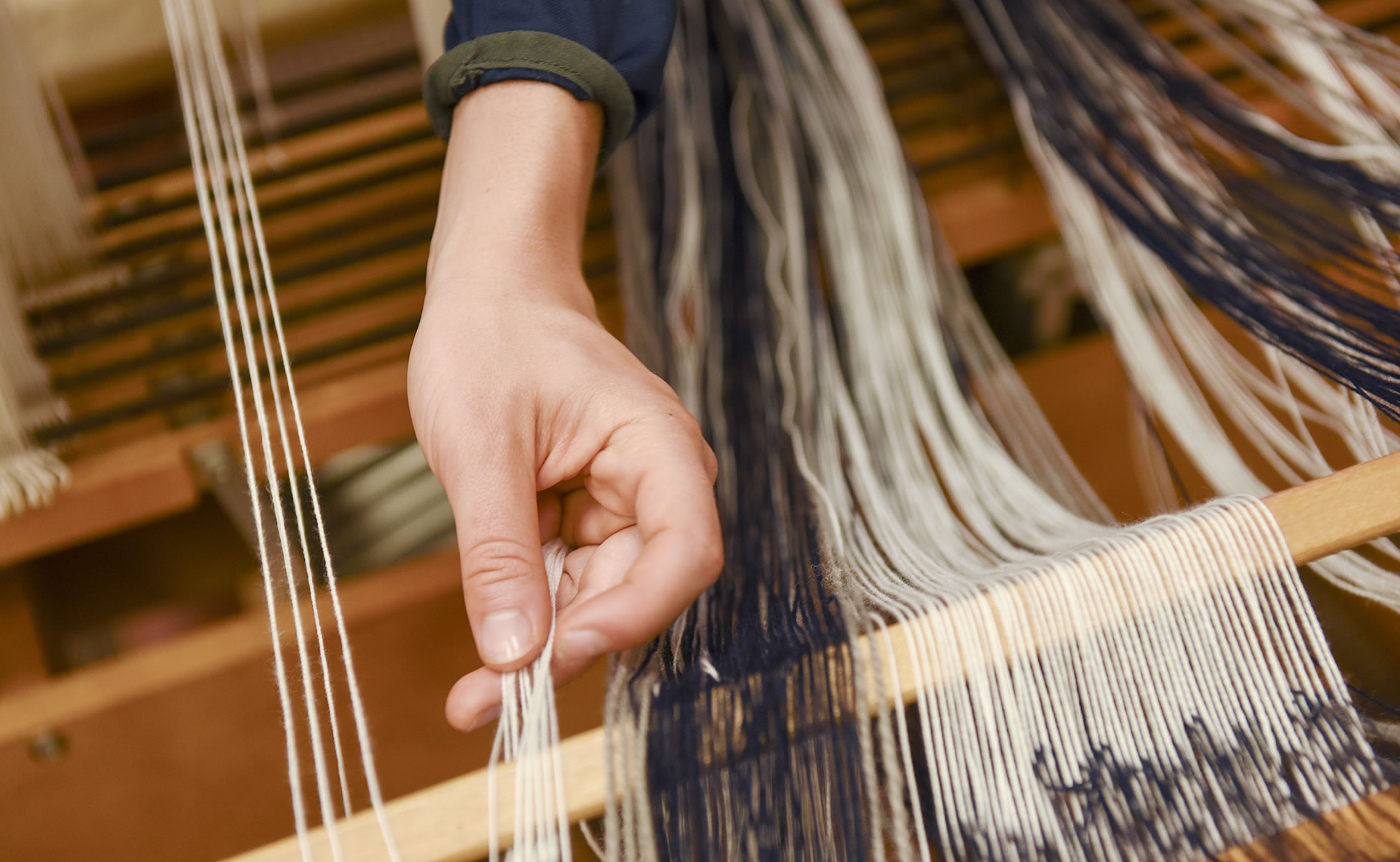 Hands weaving individual threads