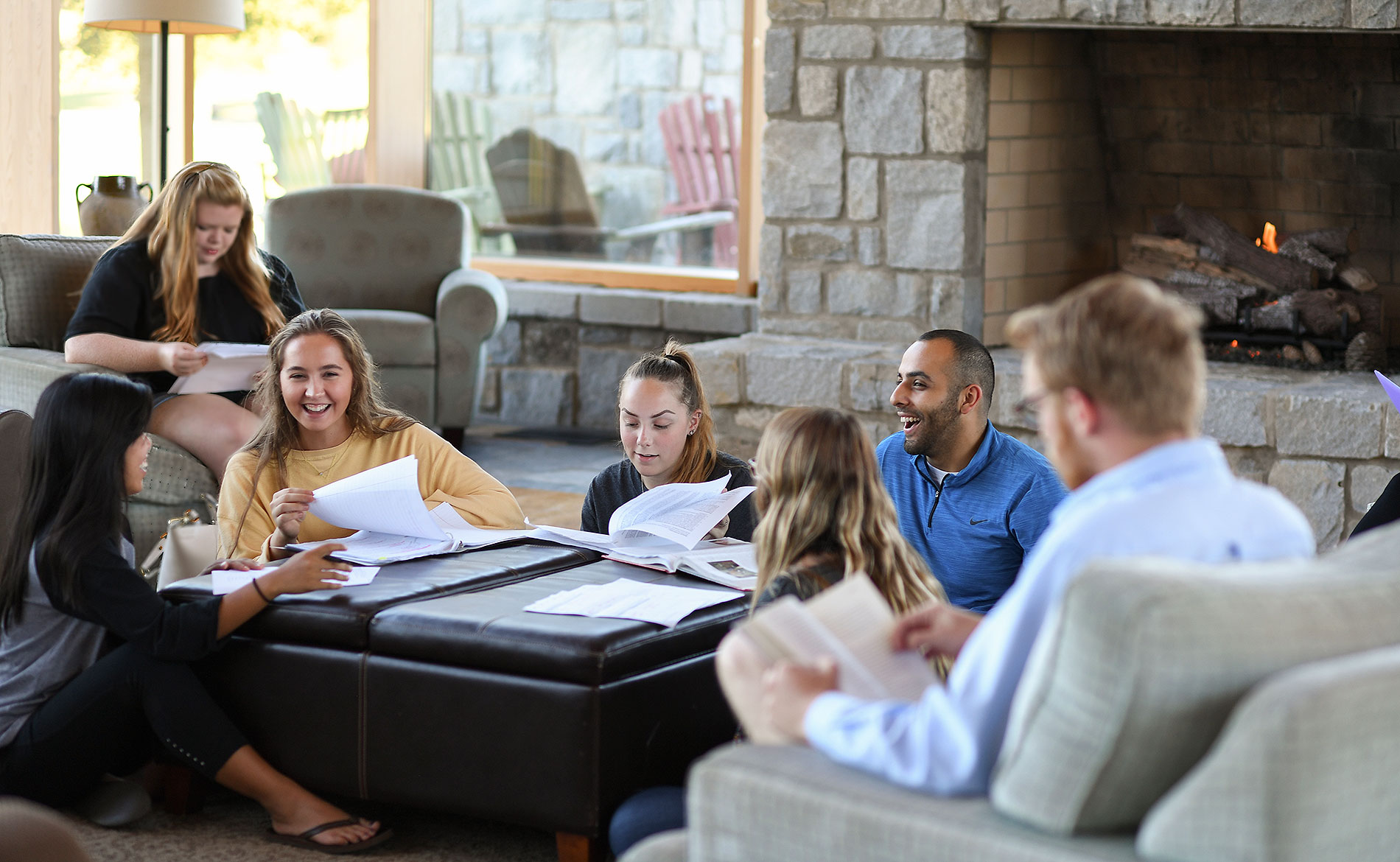 A group of students meeting in front of a fire