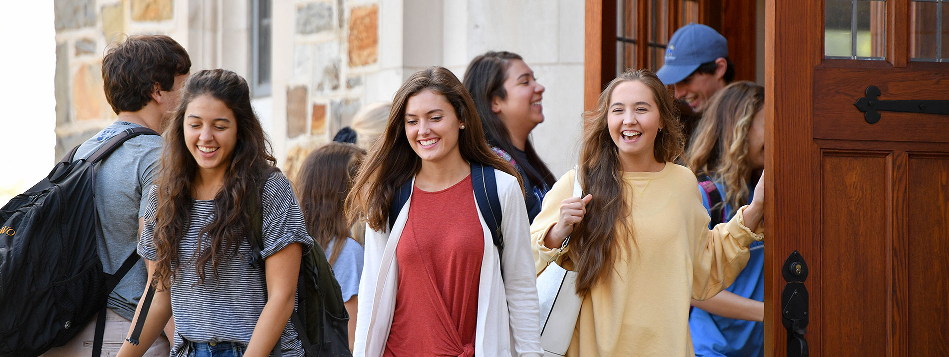 Smiling students leaving the Ford Buildings