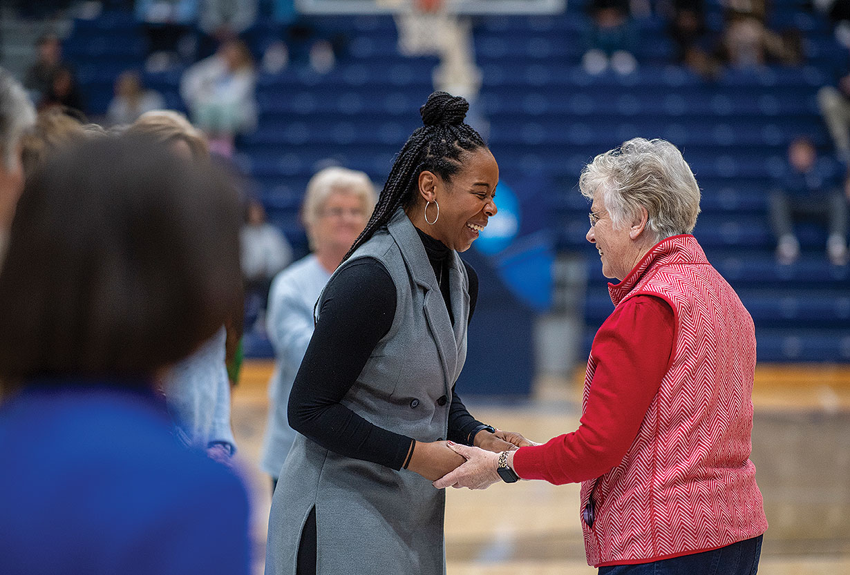 Athletic director Angel Mason meeting basketball player