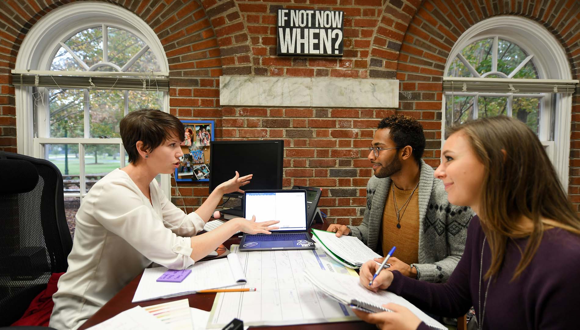 male and female students being mentored by an advisor